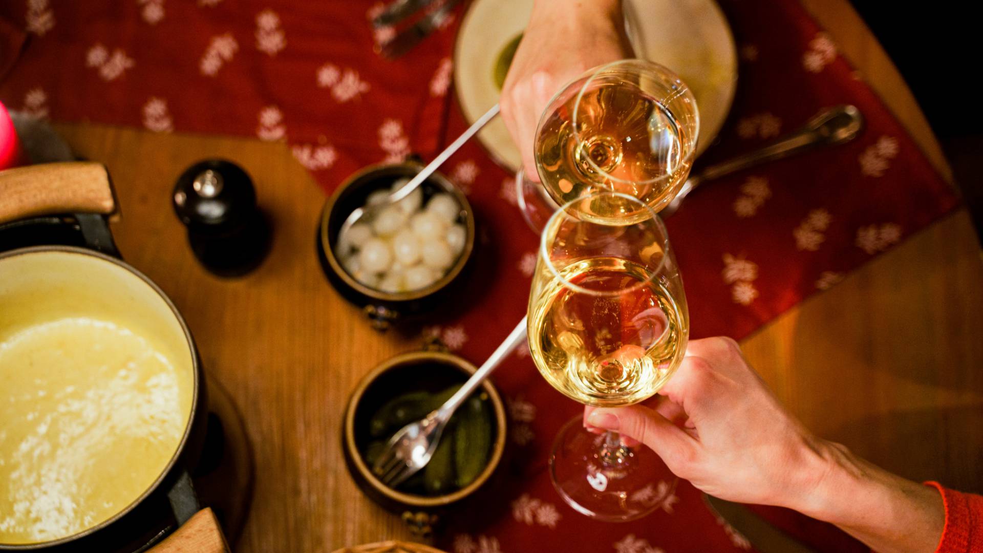 Paar stößt mit Wein beim Fondue an